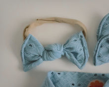 Blue bow headband on a beige background