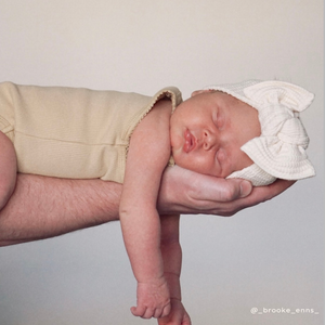 baby girl in chunky waffle bow neutral ivory sleeping